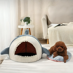 Cat peeking out of shark bed