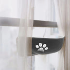 Cat resting on window perch