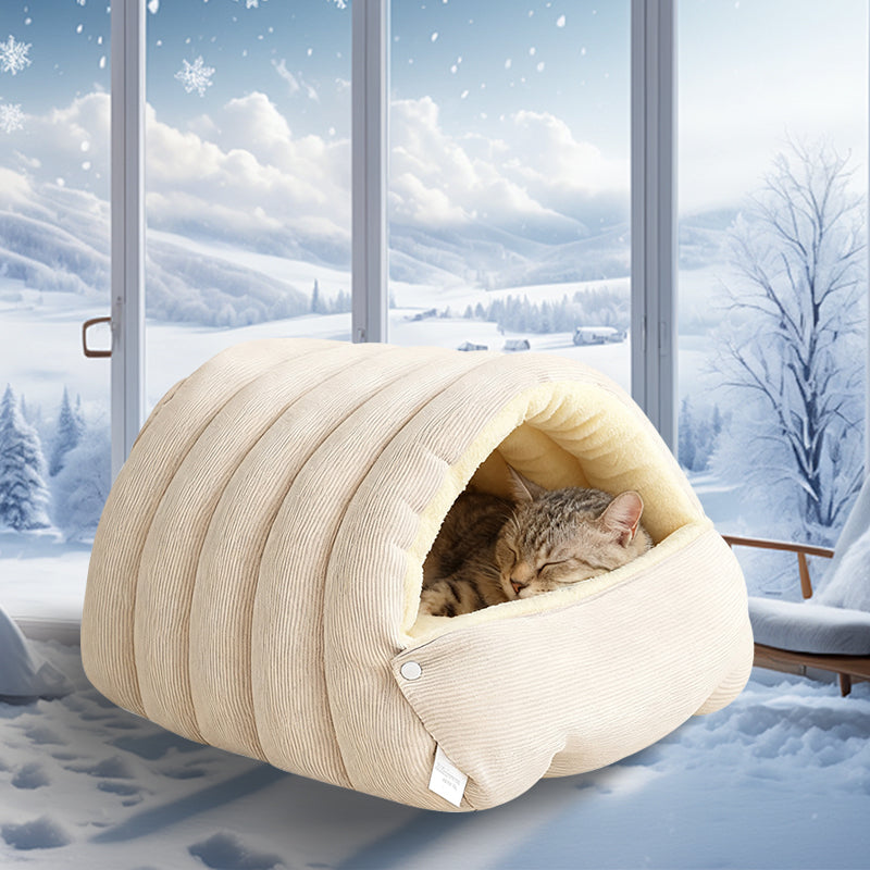 Cat resting in plush cave bed