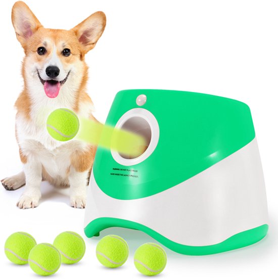 Dog with a green automatic ball launcher