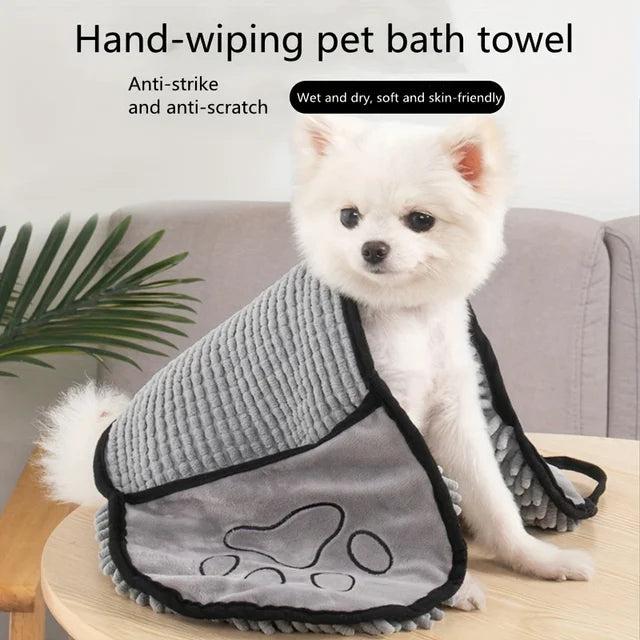 Small dog wrapped in the pet towel