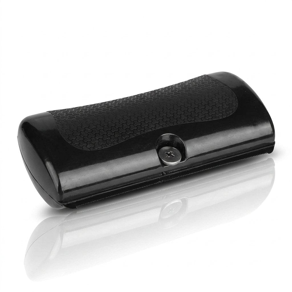 Black handheld deshedding comb with textured grip being used to groom a golden retriever's coat (view 2)