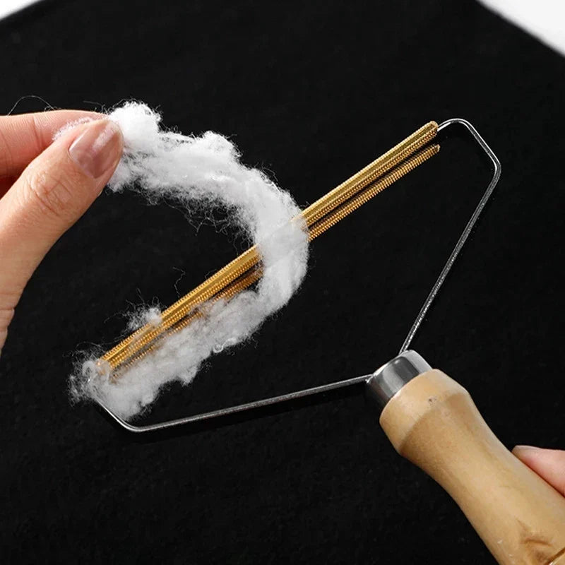 Lint remover collecting fluff from black fabric
