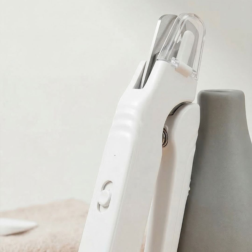 White pet nail clipper with LED light and grinder being used on a golden retriever's paw (view 4)