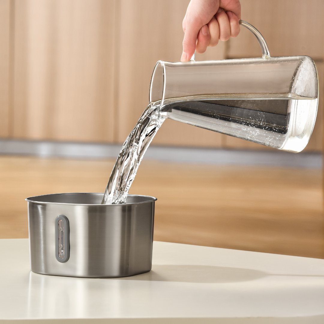 Stainless steel pet water fountain with arched spout and blue water level window, cat drinking from it (view 5)