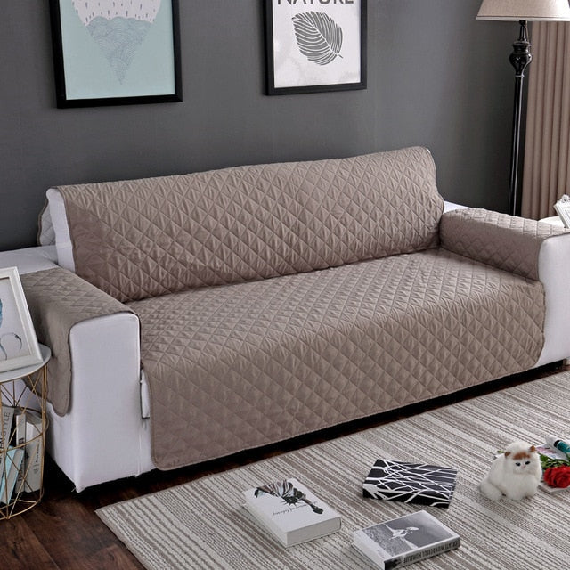 Beige quilted sofa protector