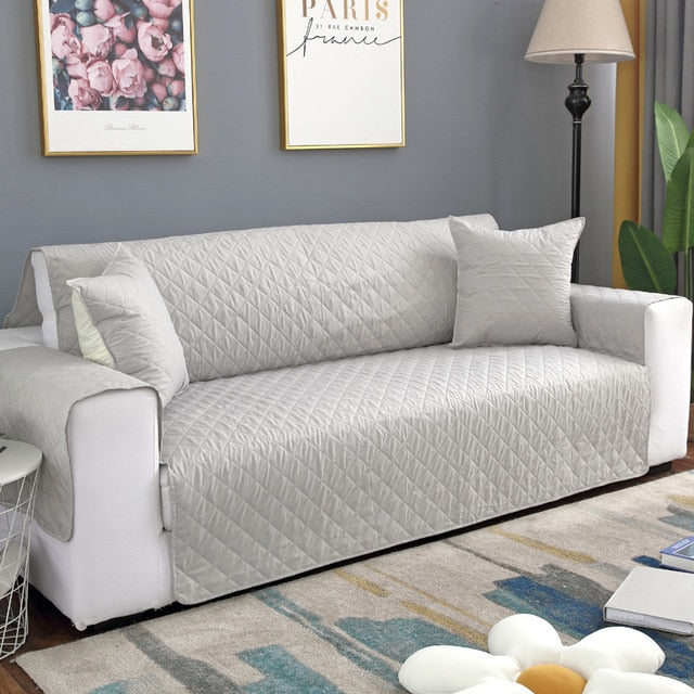 Silver quilted sofa protector
