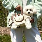 Small dog in horizontal sling carrier